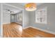 View of dining room and living room with hardwood floors at 416 N Cheatham St, Franklinton, NC 27525