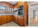 View of kitchen with knotty pine cabinets and appliances at 416 N Cheatham St, Franklinton, NC 27525