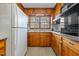 Knotty pine cabinets and appliances in galley kitchen at 416 N Cheatham St, Franklinton, NC 27525