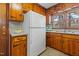 White refrigerator and knotty pine cabinets at 416 N Cheatham St, Franklinton, NC 27525