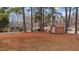 Brown metal storage shed in yard near pine trees at 416 N Cheatham St, Franklinton, NC 27525