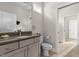 Bathroom with quartz countertop vanity and large mirror at 4201 Henderson Pl, Pittsboro, NC 27312