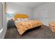 A sun-filled bedroom with colorful floral bedding at 4201 Henderson Pl, Pittsboro, NC 27312