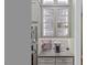 A well-organized butler's pantry featuring glass-front cabinets, under-cabinet lighting, and built-in appliances at 4201 Henderson Pl, Pittsboro, NC 27312