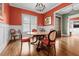 A formal dining room featuring a decorative chandelier, hardwood floors, and elegant wainscoting at 4201 Henderson Pl, Pittsboro, NC 27312