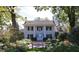 Traditional home with a symmetrical facade, white columns, and a lush landscaped front yard at 4201 Henderson Pl, Pittsboro, NC 27312