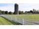 Picturesque view of a farm with a silo and white fence, showcasing the rural charm at 4201 Henderson Pl, Pittsboro, NC 27312
