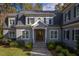 Beautiful gray home featuring a covered front entry, stone steps, mature landscaping, and a welcoming facade at 4201 Henderson Pl, Pittsboro, NC 27312