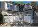 Attached three car garage featuring white doors and gray shingle siding at 4201 Henderson Pl, Pittsboro, NC 27312
