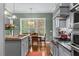 Bright kitchen with stainless steel appliances, gray cabinetry, a breakfast bar, and natural light at 4201 Henderson Pl, Pittsboro, NC 27312