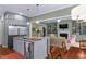 Spacious kitchen with an island, stainless steel refrigerator, open to the living room with a fireplace at 4201 Henderson Pl, Pittsboro, NC 27312