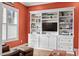 Warm living room boasting a large built-in shelf for storage and decor alongside a sunlit window at 4201 Henderson Pl, Pittsboro, NC 27312