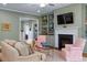 Comfortable living room features custom built-in shelves, a fireplace, and large windows at 4201 Henderson Pl, Pittsboro, NC 27312