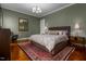 A spacious main bedroom featuring warm lighting, a neutral color palette, and a patterned rug at 4201 Henderson Pl, Pittsboro, NC 27312