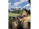 Inviting outdoor dining area featuring picnic tables and a stone fireplace, perfect for gatherings at 4201 Henderson Pl, Pittsboro, NC 27312