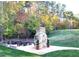 Outdoor area with picnic tables and a charming stone fireplace, ideal for community gatherings at 4201 Henderson Pl, Pittsboro, NC 27312
