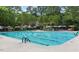 Large community pool with lap lanes, umbrellas, and lounge chairs for residents to relax at 4201 Henderson Pl, Pittsboro, NC 27312