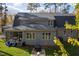 Back exterior view of a gray home featuring a screened in back porch, lush lawn, and outdoor seating area at 4201 Henderson Pl, Pittsboro, NC 27312