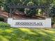 Entrance to Henderson Place featuring a large white sign with black lettering surrounded by green grass and trees at 4201 Henderson Pl, Pittsboro, NC 27312