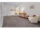 Cozy sitting room boasts neutral walls, plush gray carpet, and two comfortable armchairs with decorative pillows at 4201 Henderson Pl, Pittsboro, NC 27312
