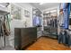 The walk-in closet features custom shelving, wooden floors and a dresser under a large window with blinds at 4201 Henderson Pl, Pittsboro, NC 27312