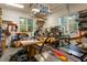 Organized workshop featuring work benches, various tools, a wall mounted dust collection system, and natural light at 4201 Henderson Pl, Pittsboro, NC 27312