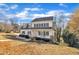 Two-story white house with gray roof, front porch, and landscaped yard at 4205 Winding Oak Way, Apex, NC 27539