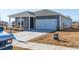 Gray house with white garage door and landscaping at 441 White Birch Ln, Angier, NC 27501