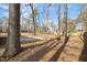 Wooded backyard with tall trees and a partially fenced area at 4901 S Pointe, Sanford, NC 27332