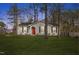 Gray house with red door, surrounded by trees, and a well-manicured lawn at 4901 S Pointe, Sanford, NC 27332