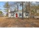 Charming single-story home with a red door, black shutters, and a well-maintained front yard in a wooded setting at 4901 S Pointe, Sanford, NC 27332