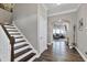 Bright entryway with hardwood floors, staircase, and view to living area at 501 Old Ride Drive, Holly Springs, NC 27540