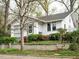 A charming home with beautiful landscaping and mature trees surrounding the property at 504 Washington St, Raleigh, NC 27605