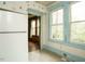 A kitchen view showing the refrigerator and three windows at 504 Washington St, Raleigh, NC 27605