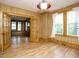Spacious living room with hardwood floors, paneled walls, and an open doorway to a dining room at 504 Washington St, Raleigh, NC 27605