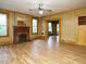 Open-concept living room featuring hardwood floors, fireplace, and wood-paneled walls at 504 Washington St, Raleigh, NC 27605