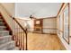 Bright living room featuring hardwood floors, a brick fireplace, and a ceiling fan at 5209 Rivington Rd, Fuquay Varina, NC 27526