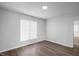 Bright bedroom with hardwood floors and a large window at 5321 Baywood Forest Dr, Knightdale, NC 27545