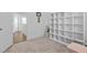 Cozy bedroom with large shelving unit and hardwood floors at 547 Vine Pkwy, Pittsboro, NC 27312