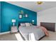 Main bedroom with teal accent wall and dresser at 547 Vine Pkwy, Pittsboro, NC 27312