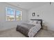 Bright bedroom with large windows and cozy bedding at 547 Vine Pkwy, Pittsboro, NC 27312