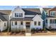 Two-story farmhouse-style home with a metal roof and front porch at 547 Vine Pkwy, Pittsboro, NC 27312