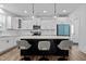 Modern kitchen with white cabinets, quartz countertops, and island at 547 Vine Pkwy, Pittsboro, NC 27312