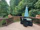 Deck with table and chairs, surrounded by greenery at 626 Churton Grove Blvd, Hillsborough, NC 27278