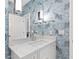 Bathroom with blue and white tiger wallpaper and a marble countertop at 805 Pinehurst Dr, Chapel Hill, NC 27517