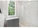 Modern bathroom with walk-in shower and grey vanity at 805 Pinehurst Dr, Chapel Hill, NC 27517