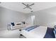 Bright bedroom with white couch and a bed with blue and white bedding at 805 Pinehurst Dr, Chapel Hill, NC 27517