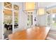 Bright dining room with large windows, wooden table, and modern light fixtures at 805 Pinehurst Dr, Chapel Hill, NC 27517