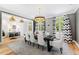 Elegant dining room with a large table, gray walls, and hardwood floors at 805 Pinehurst Dr, Chapel Hill, NC 27517