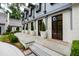 Front entry with double doors, stone steps, and large planters at 805 Pinehurst Dr, Chapel Hill, NC 27517